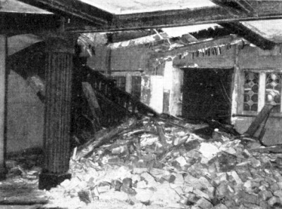 a falling chimney stack, having torn its way through roof and floors, lies scattered in its own debris at the foot of the oak staircase, and half fills the entrance hall